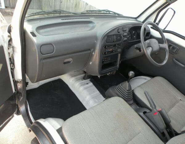 A car with the dashboard and front seats in it.