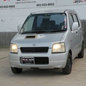 A silver van is parked in the parking lot.