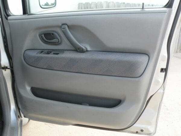 A car door with some gray leather on it