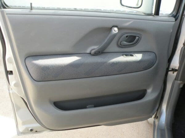 A car door with the handle open.