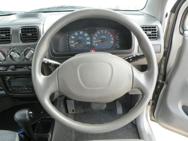 A car 's steering wheel and dashboard are shown.