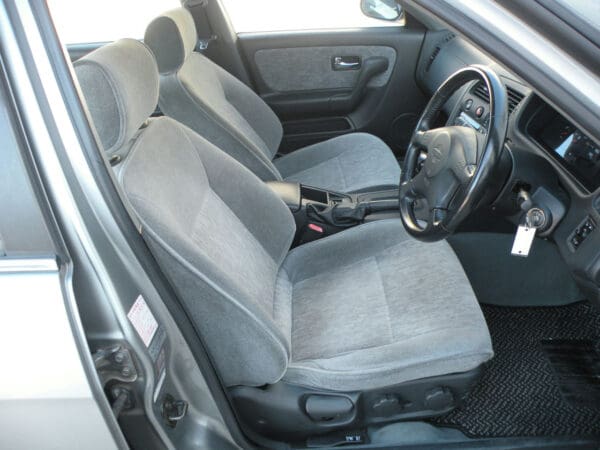 A car with grey seats and steering wheel.