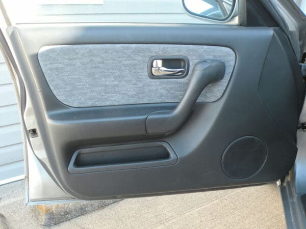 A car door handle with the door open.