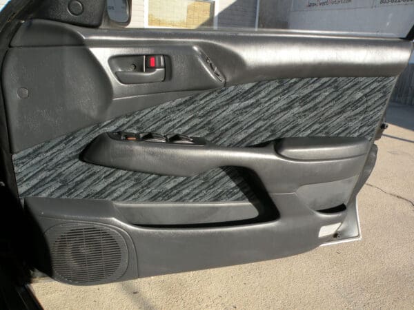 A car door handle with the seat in place.