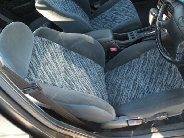 A car seat with grey and white fabric
