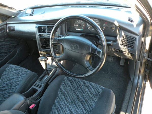 A car with the steering wheel and dashboard in view.