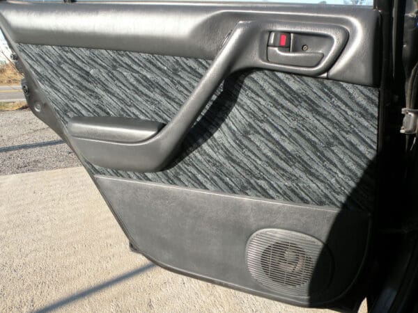 A door handle and the seat of an automobile.