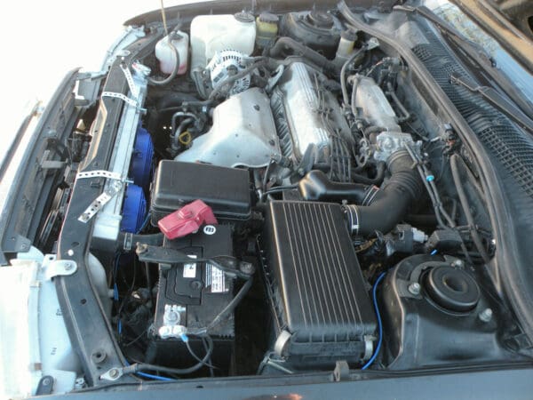 A car engine with the hood open.