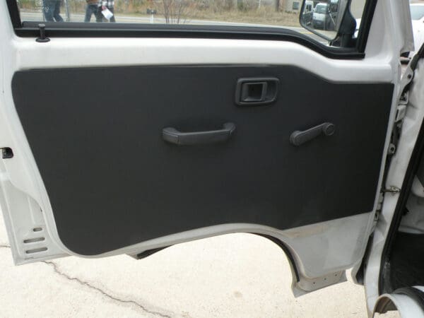 A door of an automobile with the handle on it.