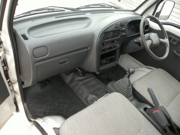A car with the dashboard and front seats in place.