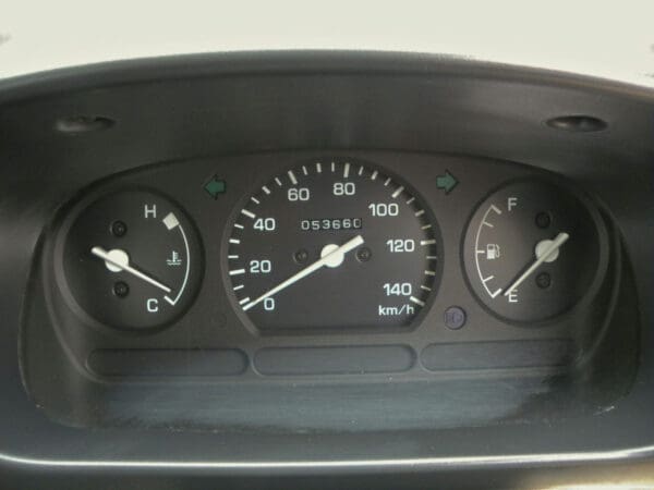 A close up of the gauges on a car dashboard