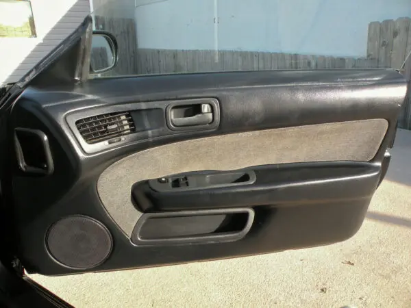 A car door with some buttons and a window