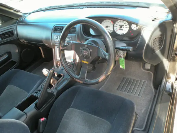 A car with the steering wheel and dashboard in view.