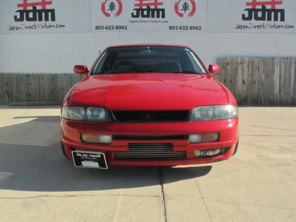 Red Japanese sports car front view.