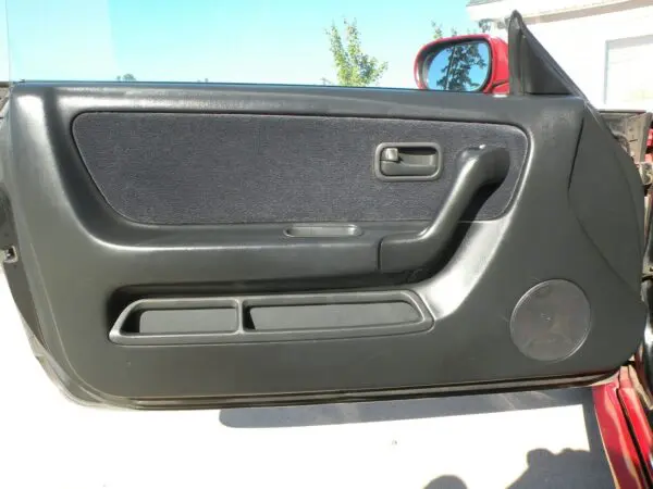 Black car door interior with speaker.