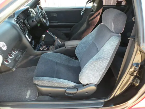 Gray fabric car seat in a car.