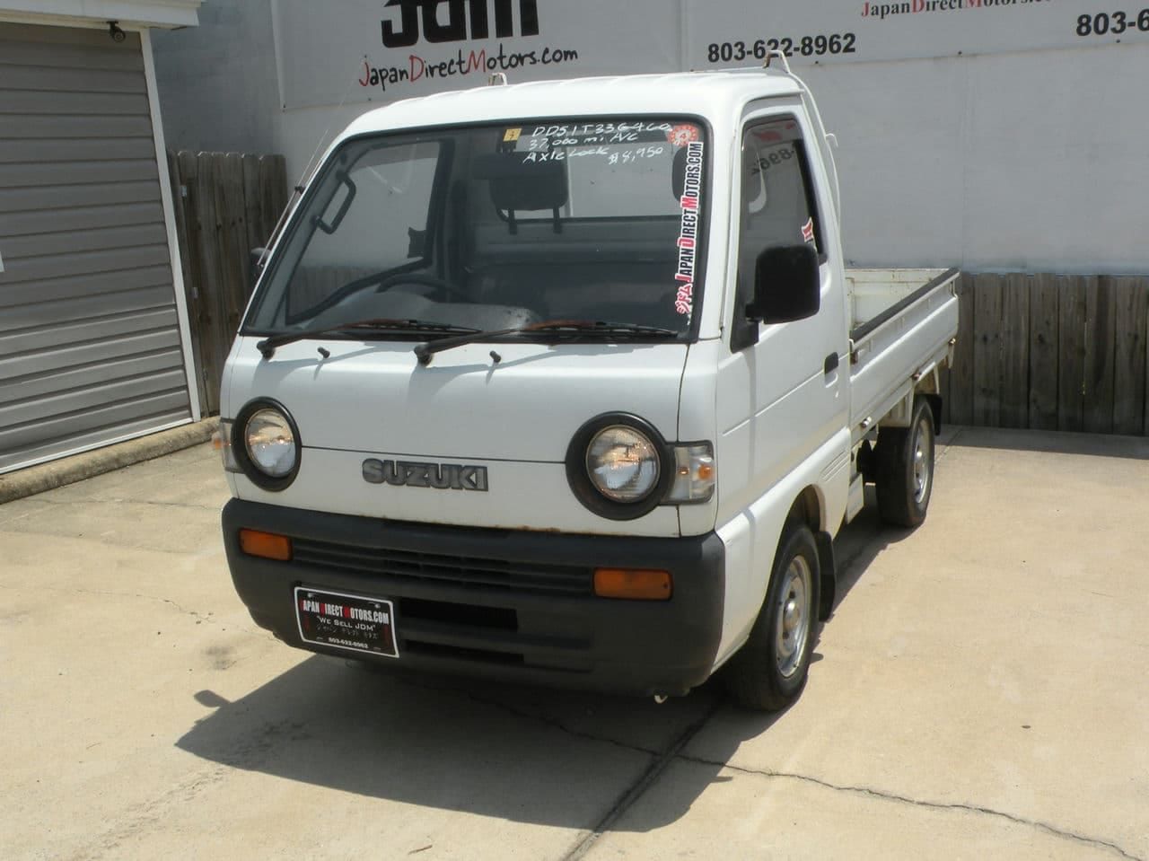 White Suzuki mini truck for sale.