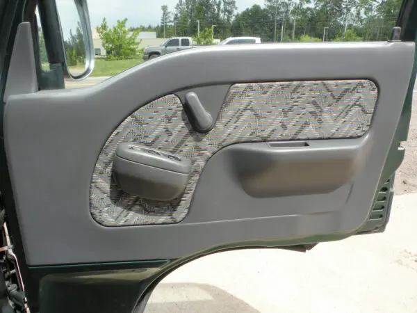 Green car door with patterned trim.