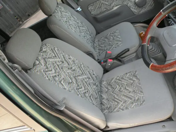 Grey patterned car seats and steering wheel.