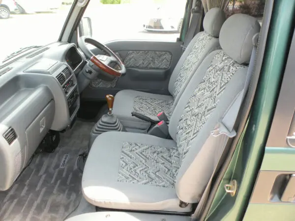 Green van interior with patterned seats.