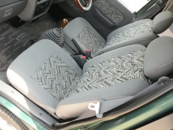 Gray patterned car seats with seatbelts.