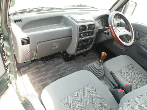 Gray car interior with steering wheel.