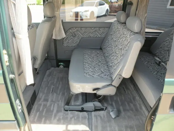 Green van interior with gray seats.