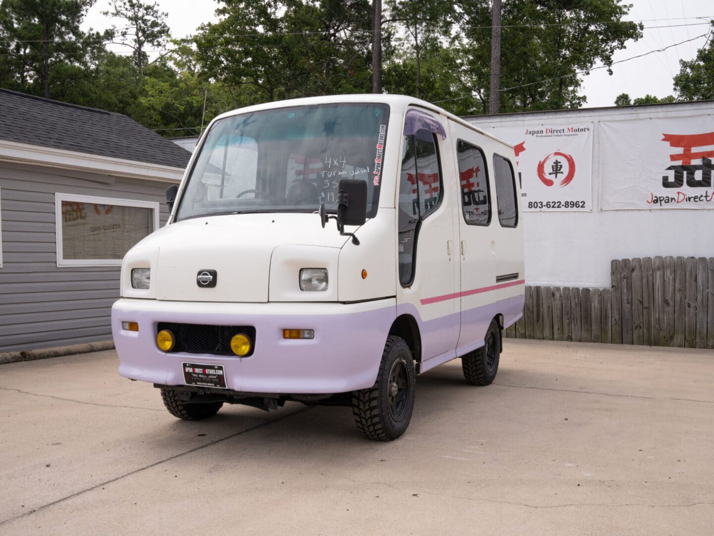 White van with Japanese writing on side.