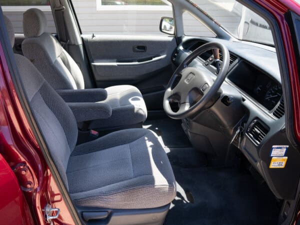 Red Honda Odyssey interior with gray seats.