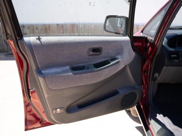 Red car door open, interior view.