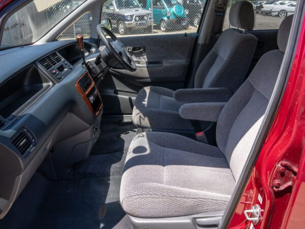 Red Honda Odyssey interior with grey seats.