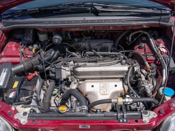 Open car hood showing engine components.