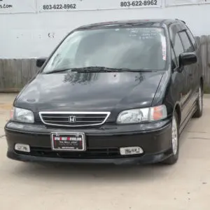 Black Honda Odyssey minivan front view.