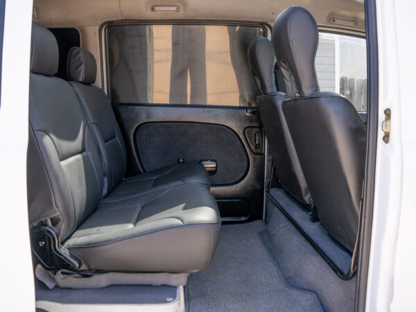 Black leather seats in a white van.