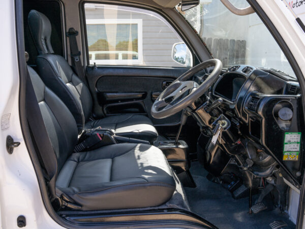 White van interior with black seats.