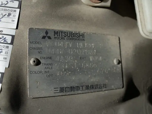 Mitsubishi Motors Corporation vehicle information tag.