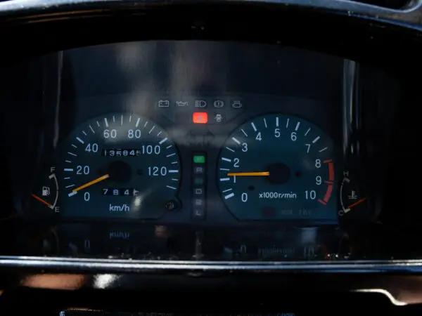 Car dashboard with speedometer and tachometer.