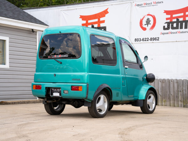 Teal Daihatsu Midget II van parked.