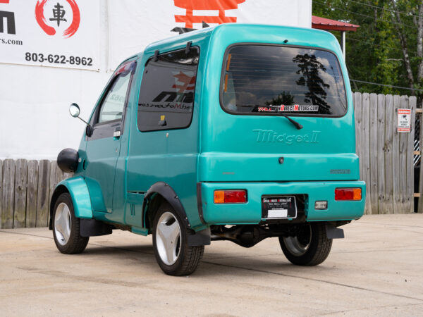 Teal Daihatsu Midget II van parked.