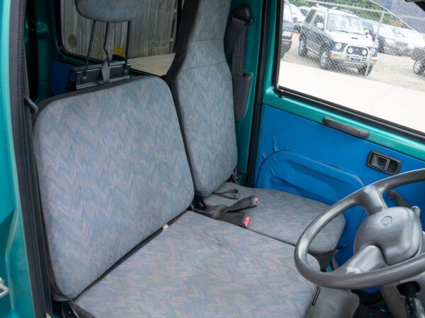 Teal van interior with grey seats.