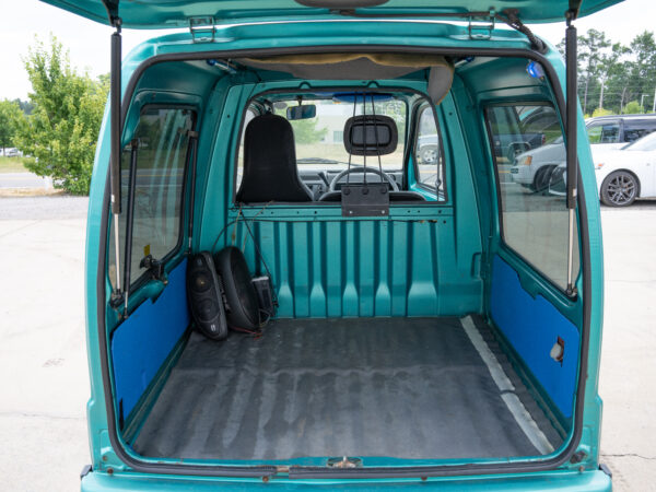 Open teal van cargo area with speakers.