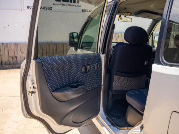 White car with open door and interior.