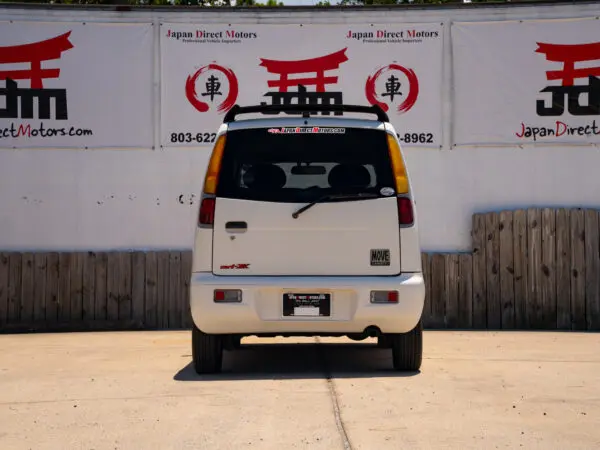 White Daihatsu Move with Japan Direct Motors logo.