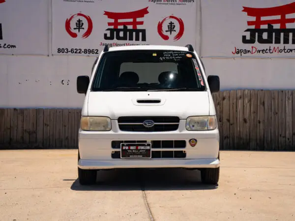 White Daihatsu Move van front view.