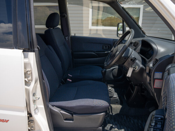 White van interior with patterned seats.