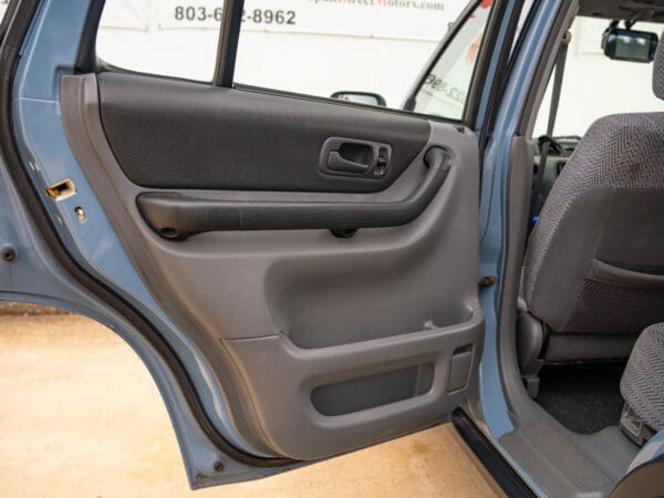 Blue SUV car door open interior view.