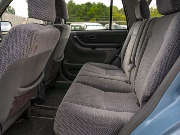 Backseat of a blue SUV with gray seats.