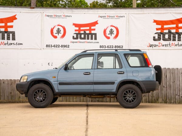 Blue Honda CRV with black wheels.