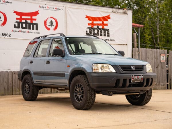 Blue Honda CR-V with black wheels.