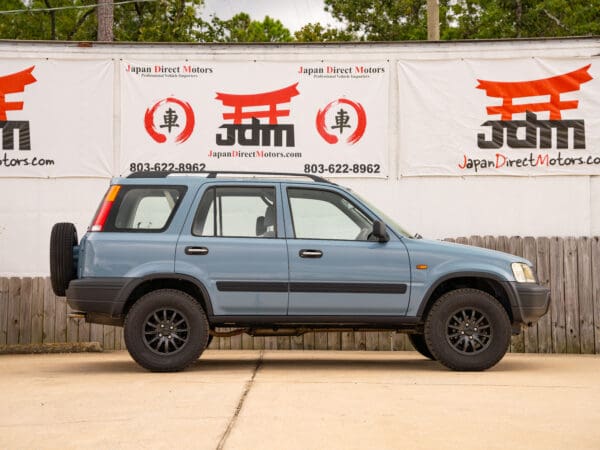 Blue Honda CR-V with black wheels.